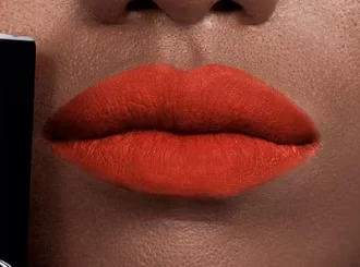 Dior 777 Fahrenheit, a tomato red lipstick, on lips