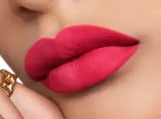 Dior 784 Rouge Rose, a raspberry red lipstick, on lips