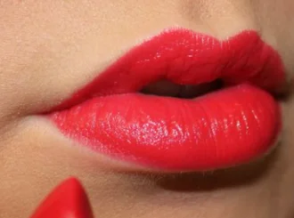 Revlon Fire & Ice, a fire-engine red lipstick, on lips