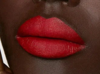Gucci Goldie Red, a brick red lipstick, on lips
