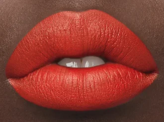 MAC Lady Danger, a poppy red lipstick, on lips