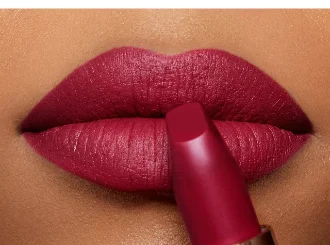 Charlotte Tilbury Love Liberty, a black cherry red lipstick, on lips