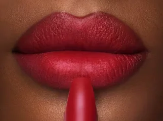 Charlotte Tilbury Red Carpet Red, an oxblood red lipstick, on lips