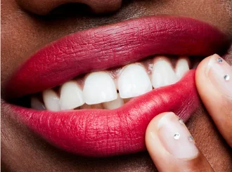 MAC Relentlessly Red, a raspberry red lipstick, on lips
