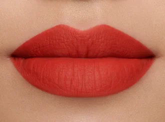 Lisa Eldridge Velvet Dragon, a tomato red lipstick, on lips